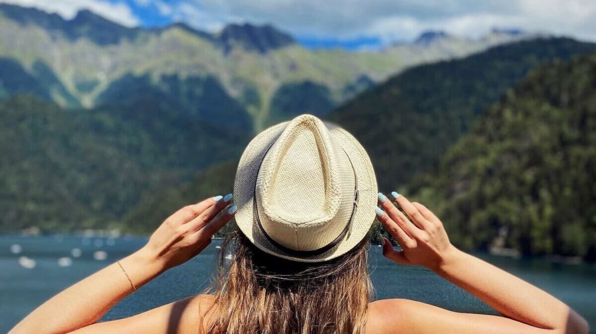 Woman thinking in front of a lake.